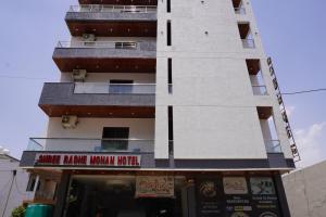 a tall white building with a white tower at Hotel Shree Radhe Mohan And Resort in Khātu