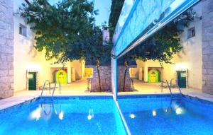 a swimming pool in front of a building at Stone house Lila Kamenmost Imotski in Kamenmost