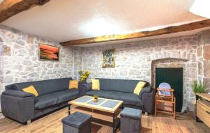 a living room with two couches and a stone wall at Stone house Lila Kamenmost Imotski in Kamenmost +51 photos