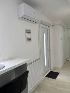 a white room with a desk and a window at Diamond apartment in Kikinda +15 photos