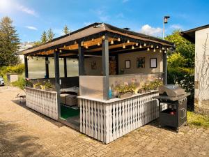 a food cart with a roof and a grill at Ferienwohnung AyNa 2, direkt an der Schweizer Grenze in Bad Säckingen
