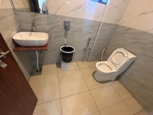 a bathroom with a toilet and a sink at Hotel Shree Radhe Mohan And Resort in Khātu +58 photos