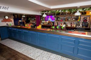 a bar with blue cabinets and a blue counter at The City in Durham