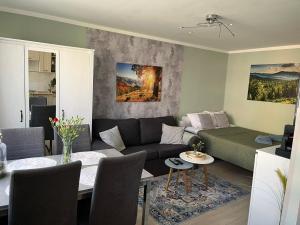 a living room with a couch and a table at Apartament Piaskowa Mountain & Coffee in Wałbrzych