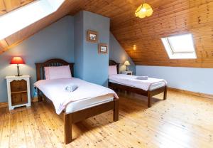 a bedroom with two beds in a attic at Crab Cottage - Portmagee in Lateeve