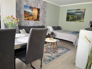 a living room with a table and a bed and a couch at Apartament Piaskowa Mountain & Coffee in Wałbrzych