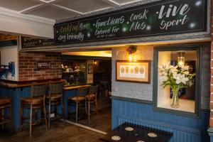 a restaurant with a bar with stools in it at The City in Durham +55 photos