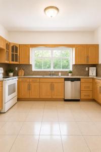 a large kitchen with wooden cabinets and a window at Safari Wynwood in Miami
