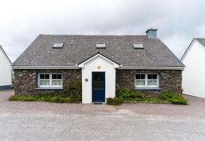 a brick house with a blue door at Crab Cottage - Portmagee in Lateeve