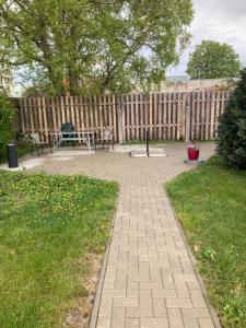 a patio with a picnic table and a fence at Dzìvoklis pie jùras in Ventspils
