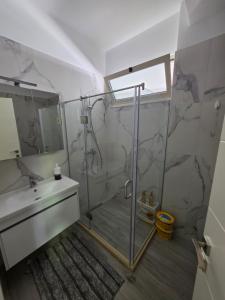 a bathroom with a shower and a sink at PERLA Vision Resort in Draç