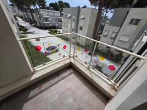 a balcony with a view of a street with buildings at PERLA Vision Resort in Draç