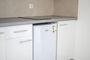 two refrigerators under a counter in a kitchen at Allma Kitesurf in Donji Štoj +27 photos