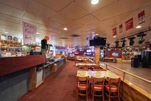 a restaurant with tables and chairs and a bar at Studio 6 Pocatello, ID in Pocatello
