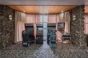 a room with four video game machines in it at Studio 6 Pocatello, ID in Pocatello +29 photos