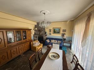 a living room with a table and a couch at Casa Della Nonna in Radicofani
