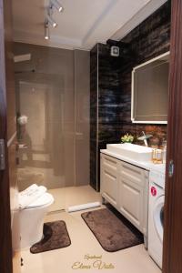 a bathroom with a toilet and a sink and a shower at Elena Vista Apartments in Štip +23 photos