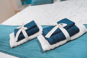 two towels sitting on top of a bed at DRM Bed&Breakfast in Marcianise