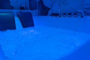 a swimming pool with blue lights in a room at DRM Bed&Breakfast in Marcianise