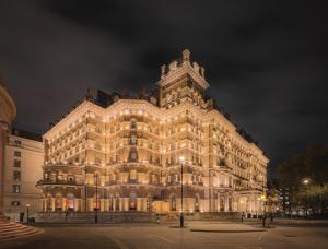 a large building is lit up at night at The Langham London in London