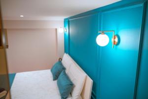 a bedroom with a blue headboard and a bed with pillows at DRM Bed&Breakfast in Marcianise