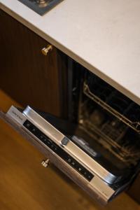 an oven with its door open in a kitchen at ММ GROUP APARTMENT in Uzhhorod