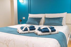 a bedroom with a bed with towels on it at DRM Bed&Breakfast in Marcianise
