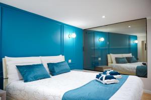 a blue bedroom with a large bed with blue walls at DRM Bed&Breakfast in Marcianise +30 photos