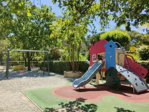 a playground with a slide in a park at Greenchalets Roquebrune Sur Argens in Roquebrune-sur-Argens