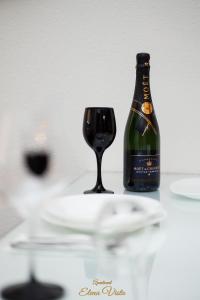 a bottle of wine sitting next to a wine glass at Elena Vista Apartments in Štip