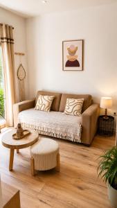 a living room with a couch and a table at Casa Luna in Saint-Chamond