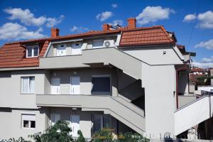a white building with a red roof at Elena Vista Apartments in Štip