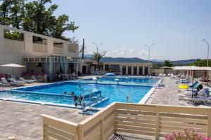 a large swimming pool with people in the water at SALTERRA Resort in Solotvyno