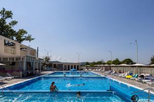 a pool at a resort with people in it at SALTERRA Resort in Solotvyno +14 photos