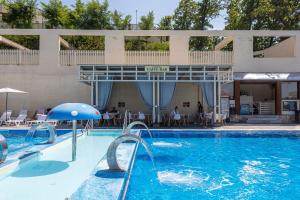 a swimming pool with an umbrella and a resort at SALTERRA Resort in Solotvyno