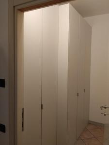 a closet with white cabinets in a room at Il Nido in Costa Masnaga
