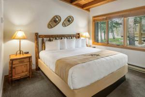 a bedroom with a large bed and a window at Evergreen Condominiums by Vail Resorts in Keystone +288 photos