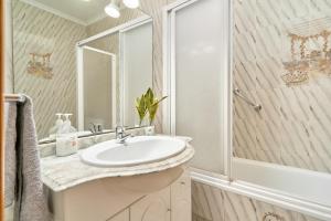 a bathroom with a sink and a shower at Vivienda junto a Plaza España in Nerja +17 photos