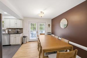 a kitchen and dining room with a wooden table and chairs at Mason Ranch - Game Room in Mason +42 photos