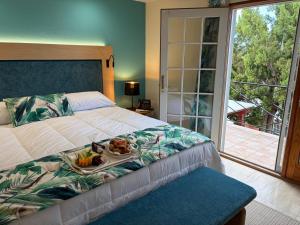 a bedroom with a bed with a tray of food on it at Fourways Inn in Chelston +24 photos