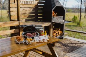 a picnic table with food on it with a grill at AfriCamps Waterberg in Vaalwater