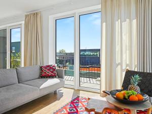 a living room with a couch and a table with fruit on it at Apartment Penthouse Seevibes by Interhome in Lembruch