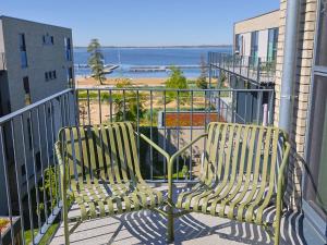 a bench sitting on a balcony looking at the ocean at Apartment Penthouse Seevibes by Interhome in Lembruch