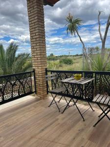 a patio with a table and chairs on a deck at Villa Remedios -rooms in private house- in Picassent