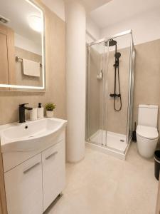a bathroom with a sink and a shower at Valentino By ERMASS ex Valentinos Apts in Paphos +20 photos