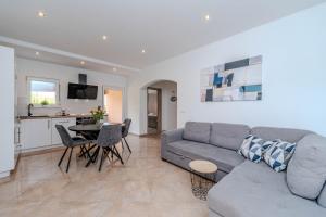 a living room with a couch and a table at Nelly Apartments in Privlaka
