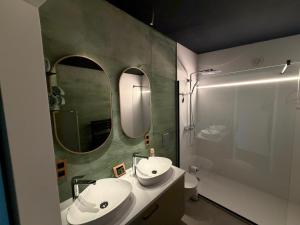 a bathroom with a sink and a mirror and a shower at Olivine 12 in La-Roche-en-Ardenne
