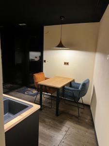 a kitchen with a table and chairs and a sink at Olivine 12 in La-Roche-en-Ardenne