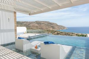 a swimming pool with a view of the ocean at Aqua Blue Villa in Amoopi