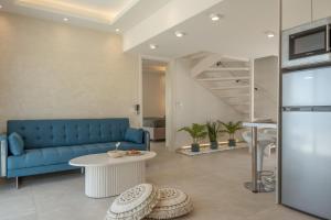 a living room with a blue couch and a table at Aqua Blue Villa in Amoopi